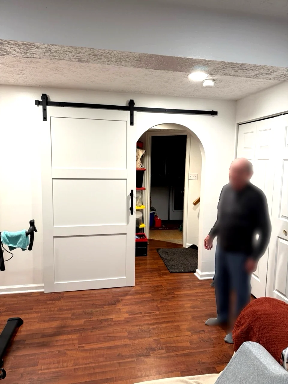 Completed drywall project with barn door and arched opening
